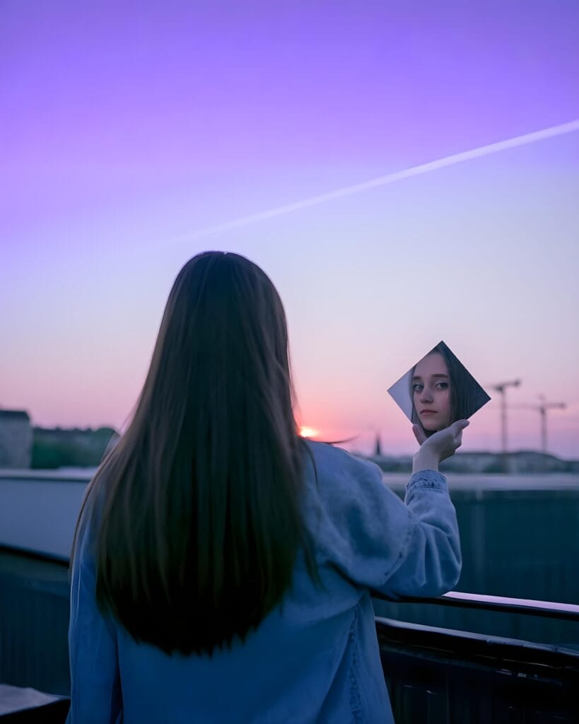 Inner Energy Webinar - Woman meditating at sunset by the lake, symbolizing peace and inner strength through SKY Yoga