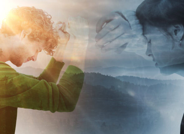 Sad pretty brunette leaning against wall against trees and mountain range against cloudy sky